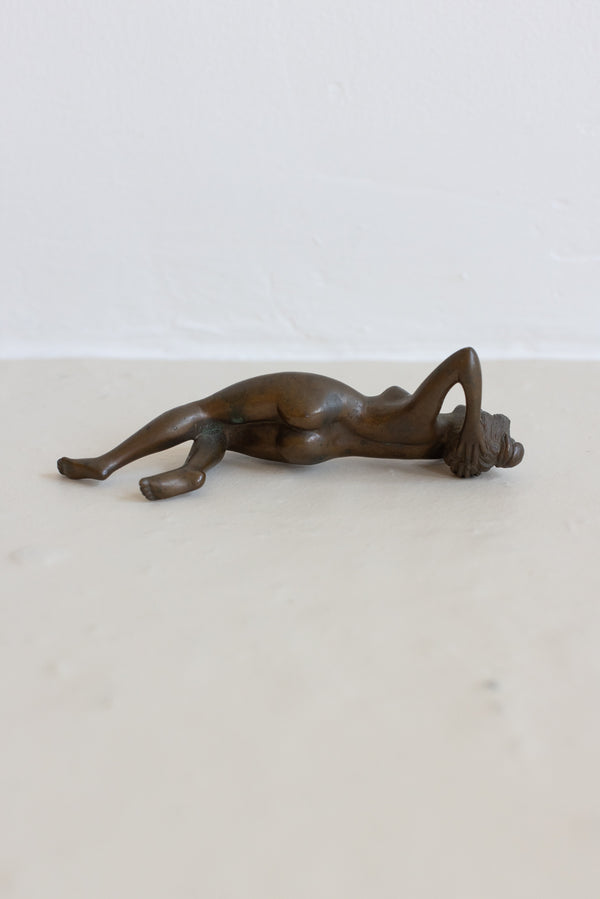 A BRONZE RECLINING NUDE