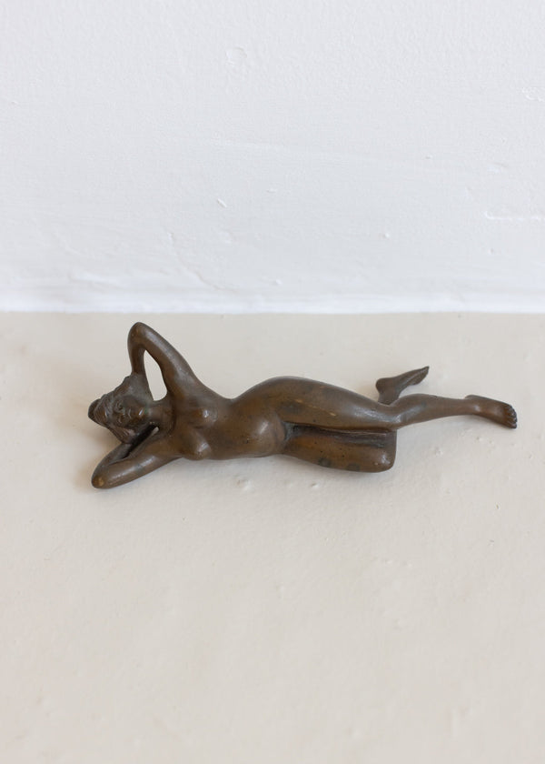 A BRONZE RECLINING NUDE